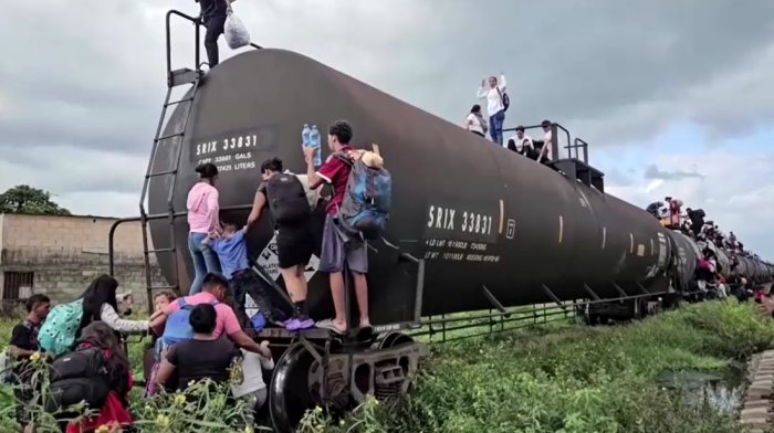 Migrant families risk life and limb boarding Mexico train in journey to border