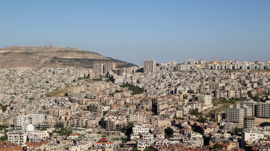 Former Assad forces surrender weapons in Damascus