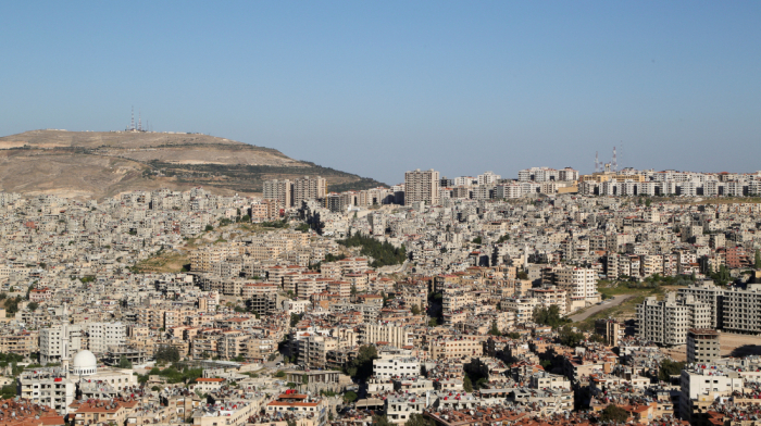 Former Assad forces surrender weapons in Damascus