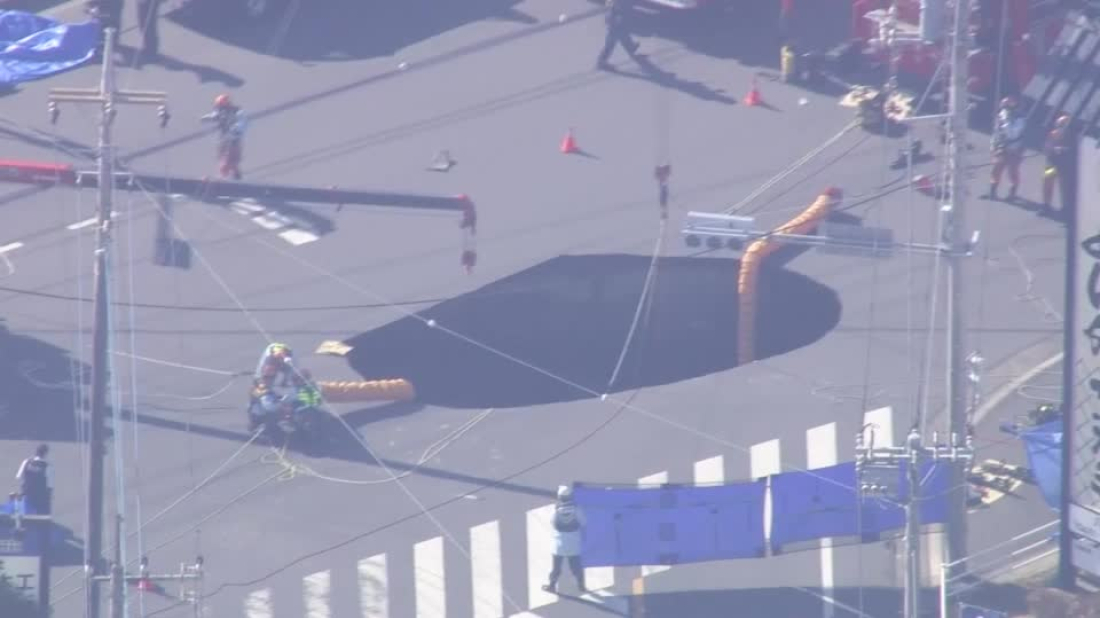 Rescuers attempt to recover truck swallowed by sinkhole in Japan