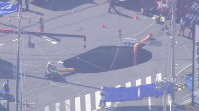 Rescuers attempt to recover truck swallowed by sinkhole in Japan