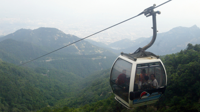 Robotic exoskeletons help Chinese tourists climb the country’s most punishing mountain