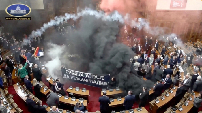 Serbian lawmakers injured in parliament amid smoke bombs and flares