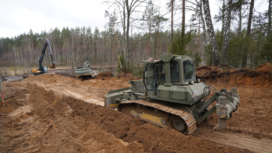 Rescuers dig for missing U.S. soldiers' vehicle in Lithuania