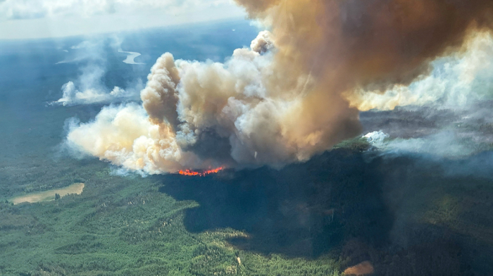 Wildfires force over 26,000 to flee homes in western and central Canada