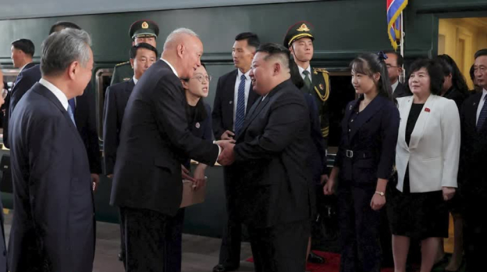 North Korea's Kim shakes hands with South Korean parliament speaker