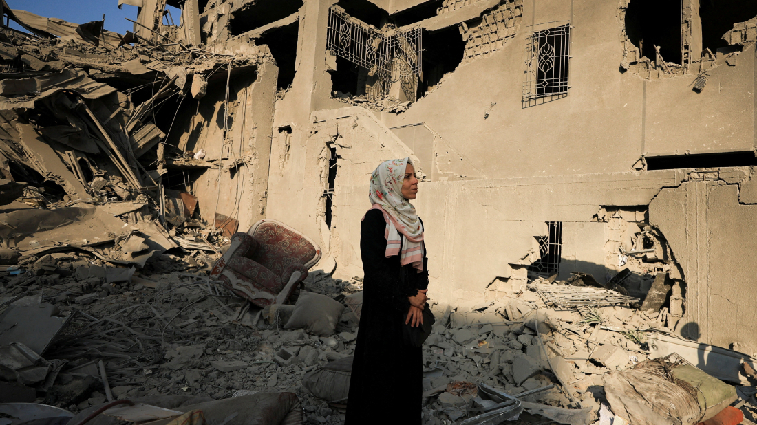 Palestinians search through the rubble of a building hit by Israel in Gaza City