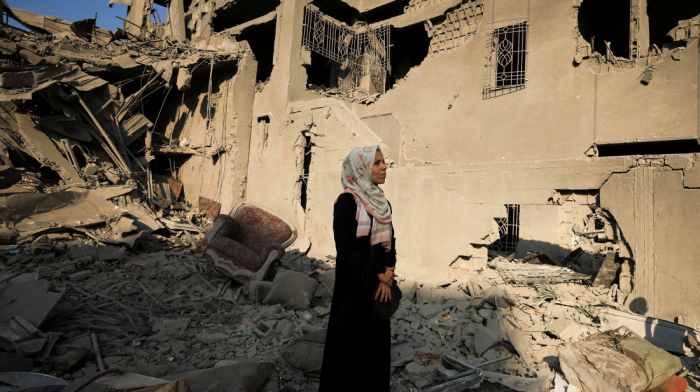 Palestinians search through the rubble of a building hit by Israel in Gaza City
