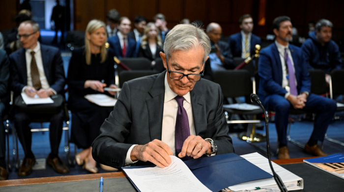 Federal Reserve cuts interest rates, trims workforce