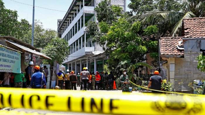Ambulances at collapsed Indonesian school as student search continues