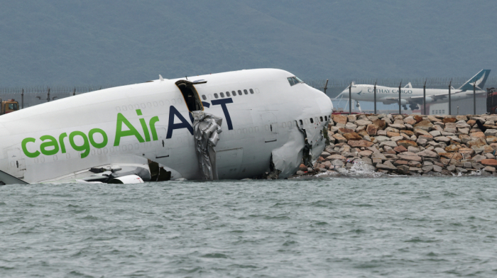 Cargo plane slides off runway in Hong Kong, killing two airport staff