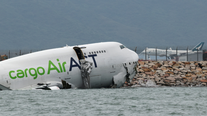 Hong Kong investigators say cargo jet engine surged before fatal airport crash