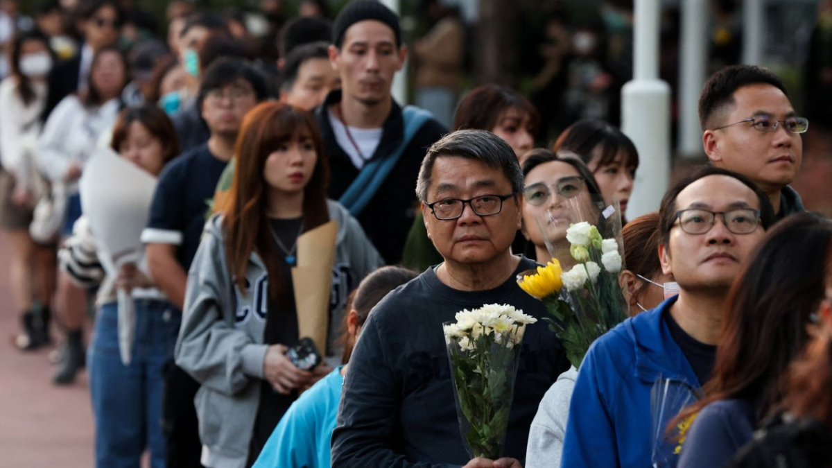 Mourners flock to site of deadly Hong Kong blaze as Beijing warns against protests