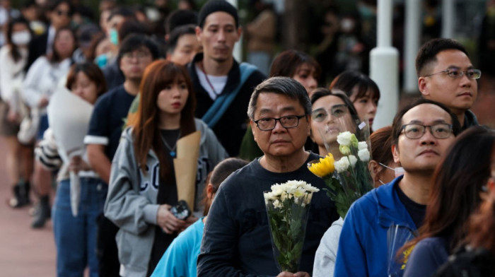Mourners flock to site of deadly Hong Kong blaze as Beijing warns against protests