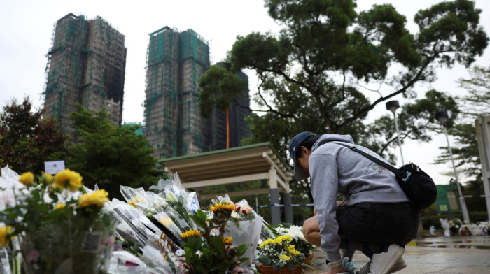 Mourners flock to site of deadly Hong Kong blaze as Beijing warns against protests