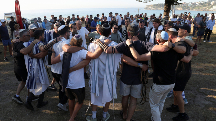 Australia plans gun buyback after Bondi massacre, as surfers honour victims