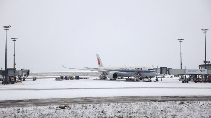 Snowstorm-hit travellers bed down in Amsterdam airport, Parisians take to skis