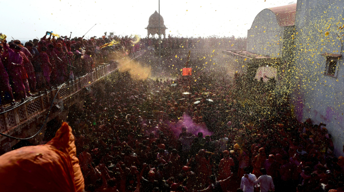 Sweets and colours fill the air at 'Laddoo Holi' festival in Uttar Pradesh, India