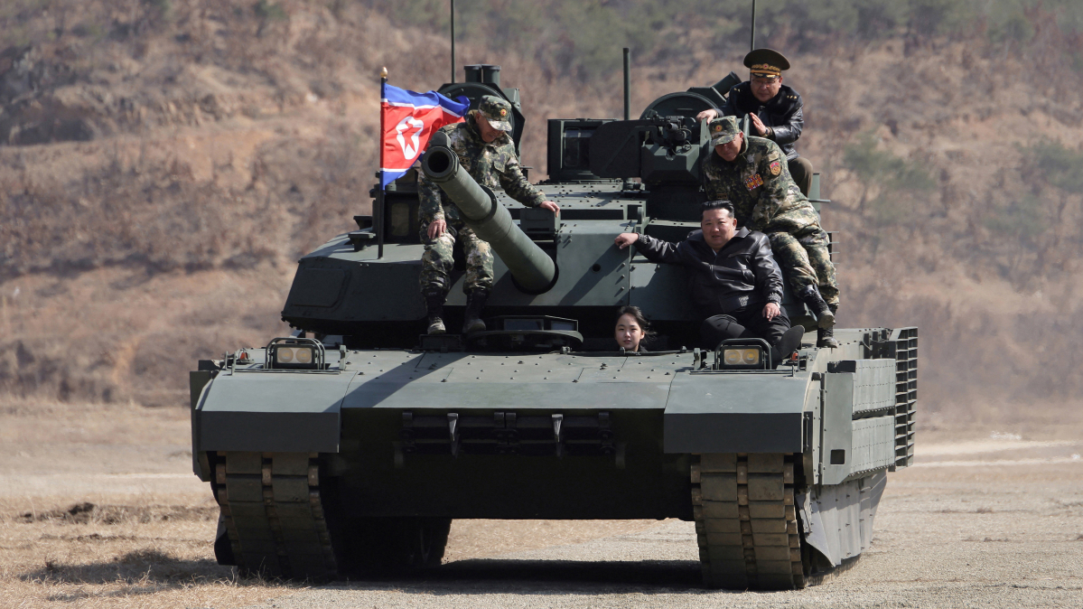North Korea: Ju Ae drives an army tank as father Kim Jong Un watches