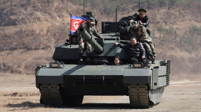 North Korea: Ju Ae drives an army tank as father Kim Jong Un watches