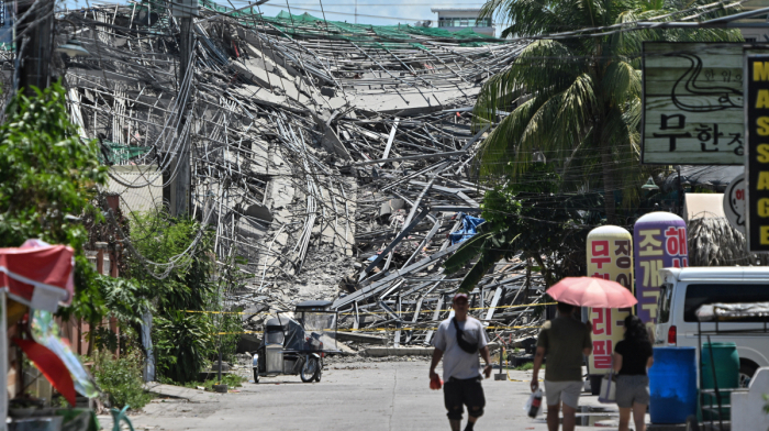 Rescuers search for more than 20 trapped after Philippines building collapse