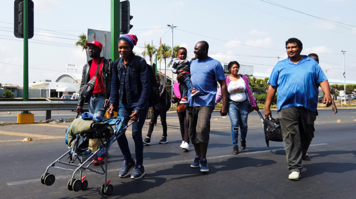 U.S. urges migrants on temporary status to seek residency or leave