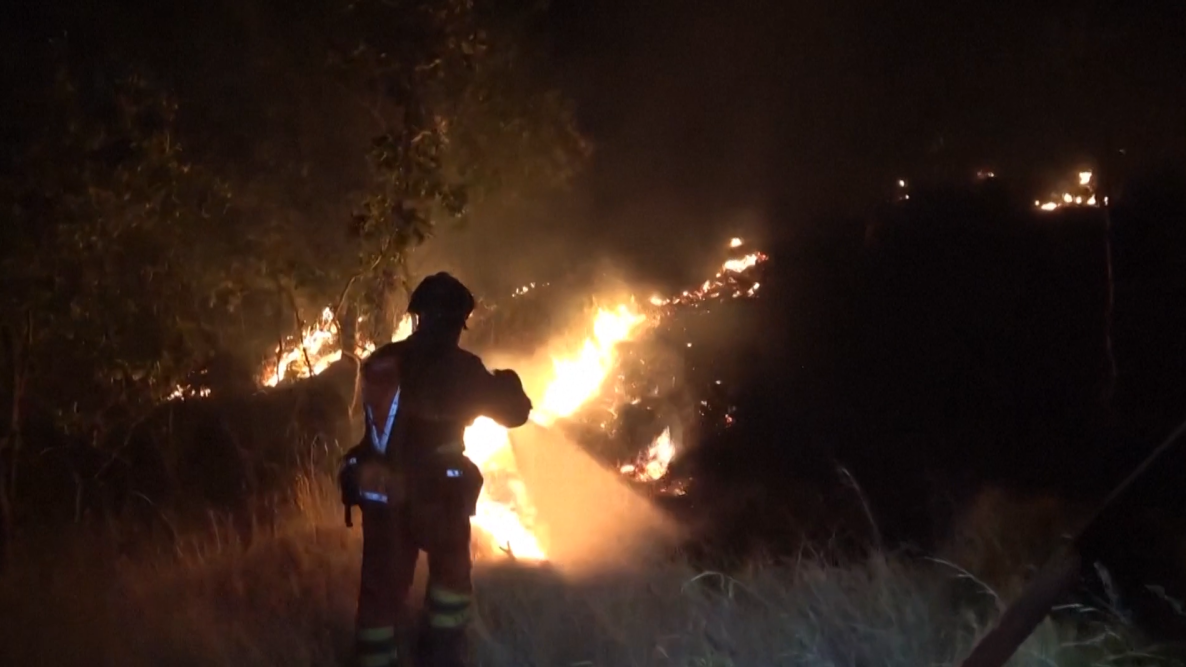 Firefighters tackle flames at wildfire in Spain hampered by strong winds