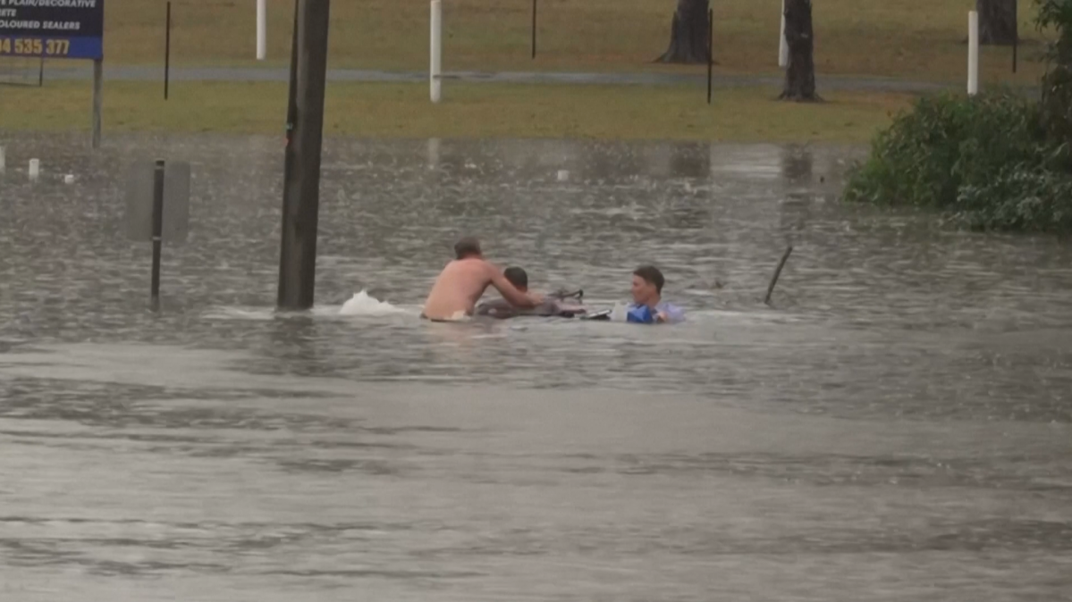 Australian TV reporter rescues man from sinking car during floods