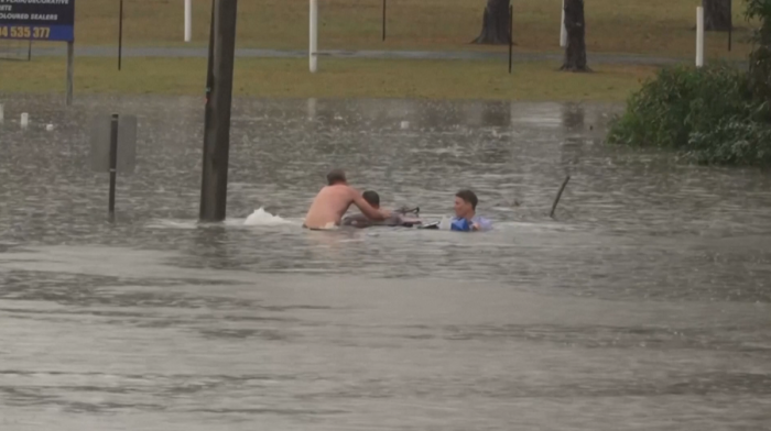 Australian TV reporter rescues man from sinking car during floods